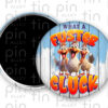 What a Fuster Cluck magnet button with blue and white wood background